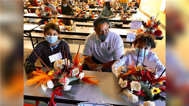 Dr.Hammond and students making center pieces.